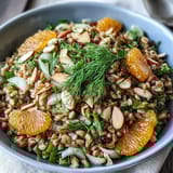 Nutty farro, crisp fennel, juicy orange segments, and crunchy almonds create a vibrant, refreshing salad bowl.