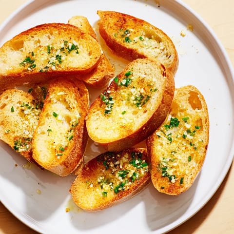 Golden, crispy garlic bread slices, toasted with herb butter and perfect for Italian meals.