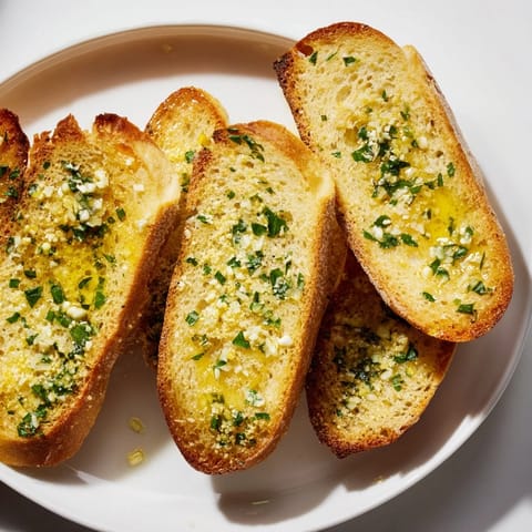 Warm, buttery garlic bread with golden-brown, inviting crusts, ideal side for your dinner.