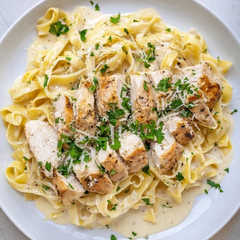 A comforting close-up shot of fettuccine Alfredo, featuring perfectly cooked pasta and creamy sauce.