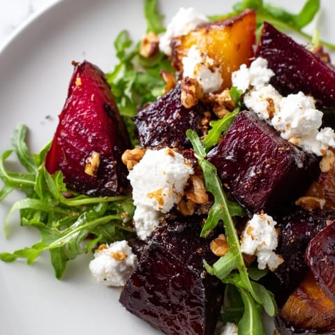 Vibrant red beets, crumbled goat cheese, and toasted walnuts over a bed of peppery arugula, finished with a bright balsamic dressing.  