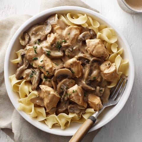 Golden-brown chicken and sliced mushrooms simmer in a rich, paprika-infused sauce for a comforting dinner.