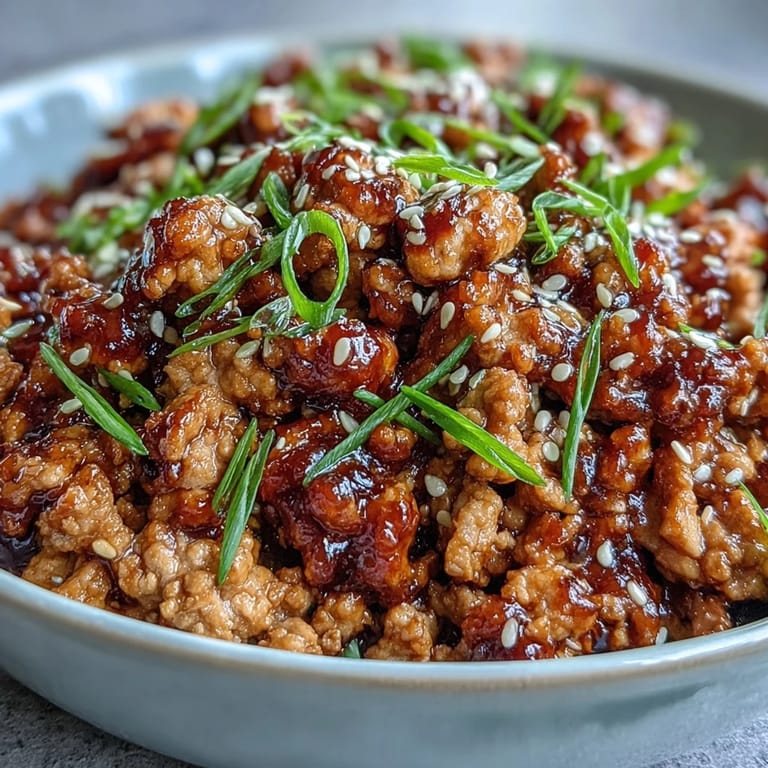 Sizzling Korean-style ground turkey in a pan, featuring a glossy, spicy-sweet sauce and aromatic garlic and ginger.