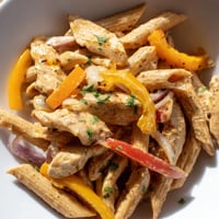 Creamy Cajun Chicken Pasta Lite features al dente penne and tender chicken strips tossed in a spicy, lighter cream sauce with colorful bell peppers.  